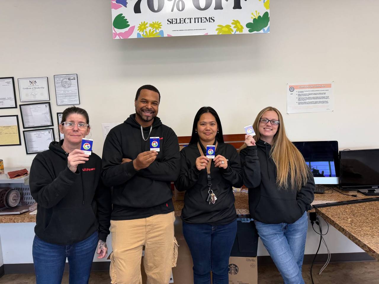 The US Pawn crew holding their review tap cards